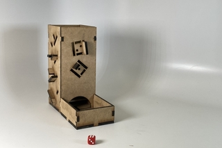a fiberboard dice tower with dice cutouts as decorations